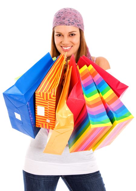 woman with shopping bags smiling - isolated over a white background