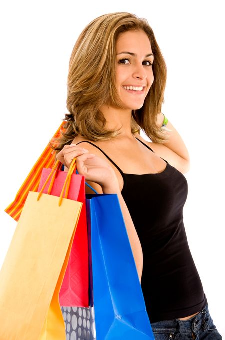 Casual woman with shopping bags smiling and isolated on white