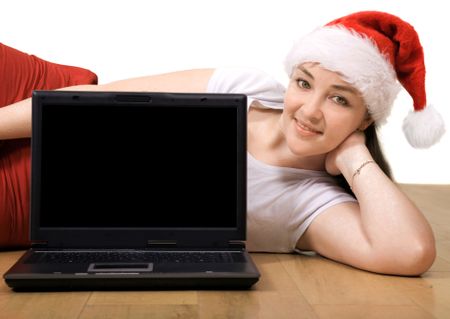 Beautiful girl with a laptop lying on the floor