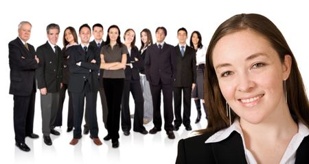 business woman facing the camera with his team behind him