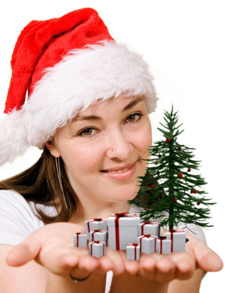 christmas female santa holding a christmas tree and gifts on her hands - focus is on face