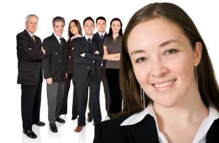 business woman facing the camera with her team behind her - focus is on the team behind