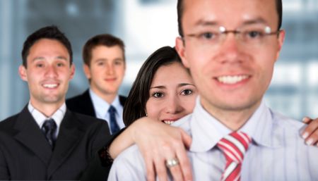 business team full of young entrepreneurs with a guy in glasses leading - focus is on the girl behind him