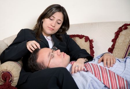 tired business partners on a sofa in their home