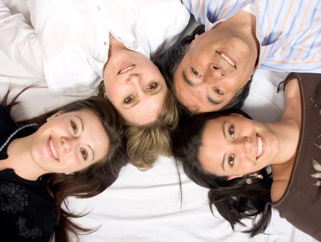 beautiful family on the floor over a white sheet