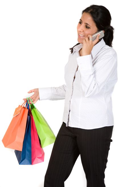 girl with shopping bags on the phone over a white background