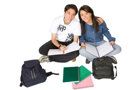 casual students studying on the floor over a white background