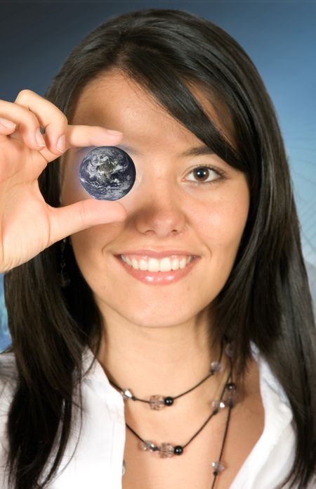 Business woman holding a globe over a dark background
