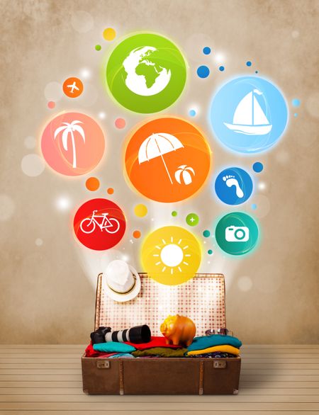 Suitcase with colorful summer icons and symbols on grungy background