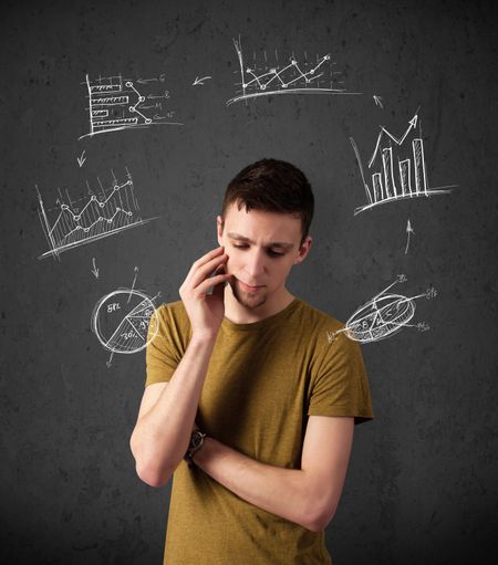 Thoughtful young man with drawn charts circulating around his head