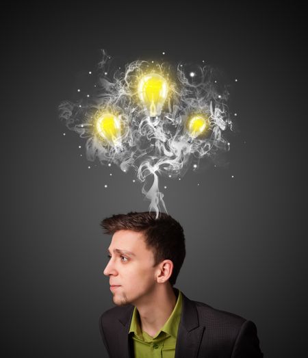 Young businessman with smoke and lightbulbs concept