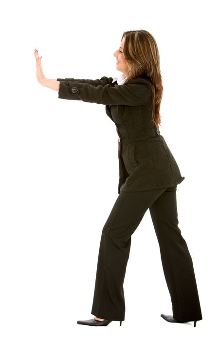 business woman pushing something isolated over a white background