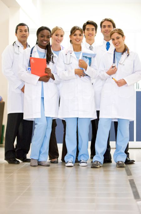 group of doctors smiling and standing in a hospital