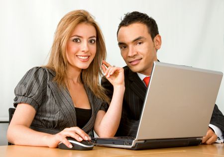 business partners in an office on a laptop computer