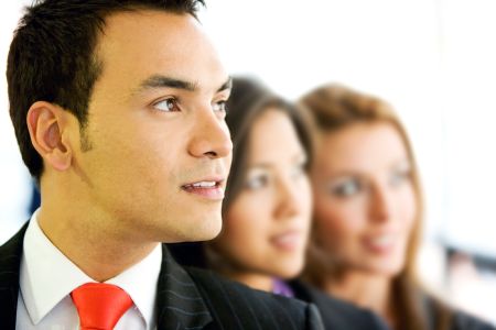 businessman with two more people in an office smiling - small team