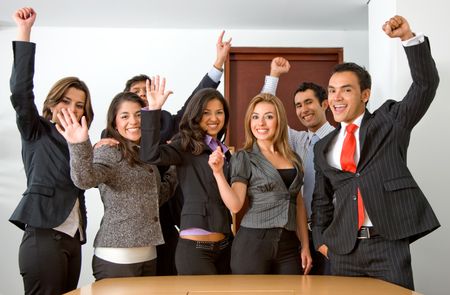 business team in an office full of success looking happy