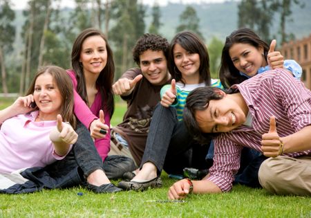 friends or university students smiling outdoors in a park