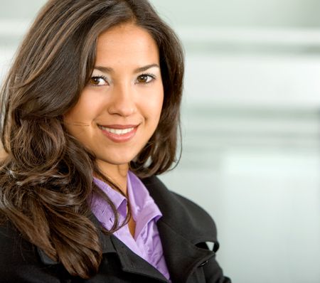 business woman portrait in an office smiling