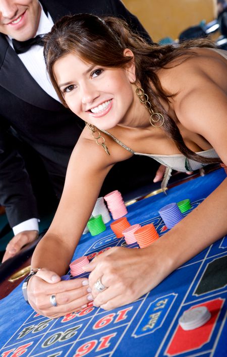 casino woman smiling and gambling on the roulette