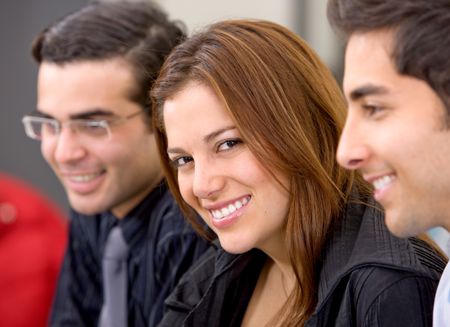 businesswoman and her business team in an office smiling