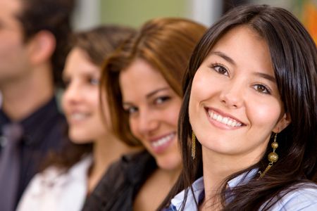 business people in an office smiling - woman leading