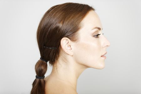 Beautiful young woman in a beauty style pose in profile view