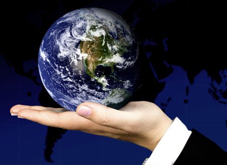 business hand holding a globe with the world map in the background