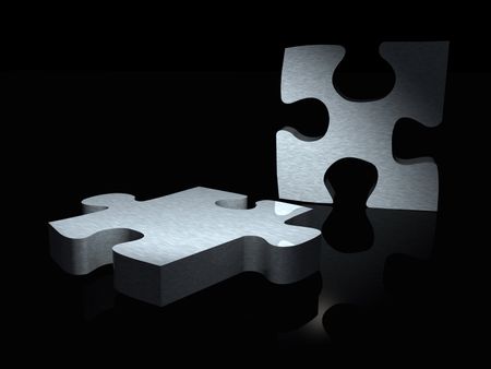 couple of metal puzzle pieces over a black background