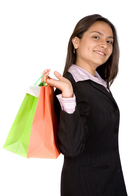 beautiful business woman with shopping bags over white