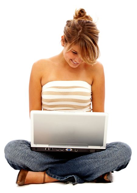 Beautiful girl studying - smiling and writing on her laptop