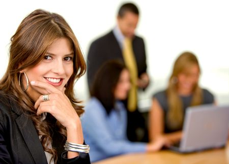 business woman smiling with her team in an office