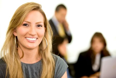 business woman smiling with her team in an office