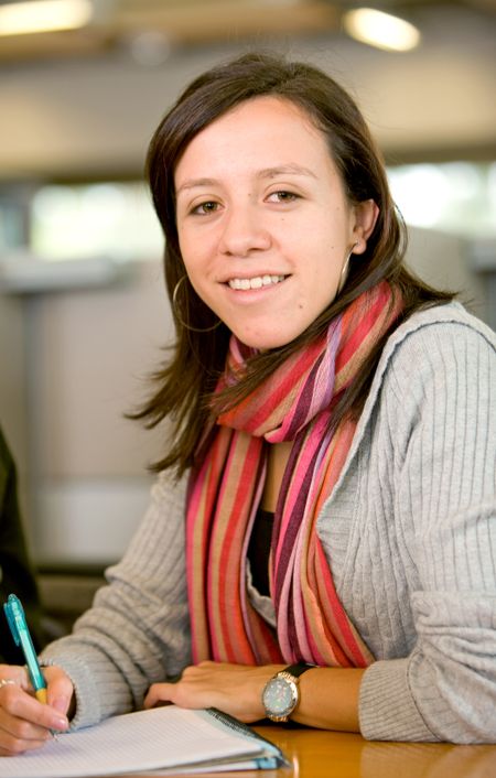female university student in a classroom smiling