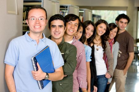 library students smiling  with a man in glasses leading the group