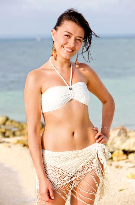 happy woman at the beach smiling in a bikini