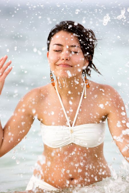 beach woman splashing water on her face