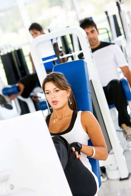 group of people at the gym doing exercise on the machines