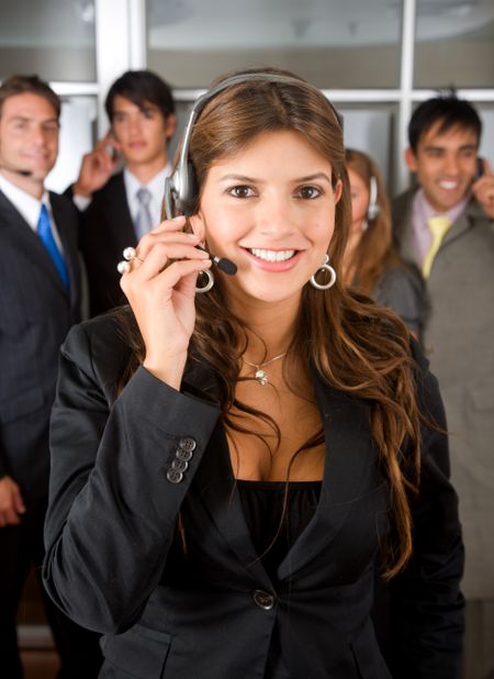 business customer service woman smiling with her team behind