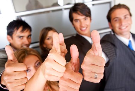 group of business people with thumbs up in an office