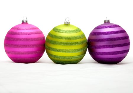 christmas balls in purple - pink and green on a soft surface