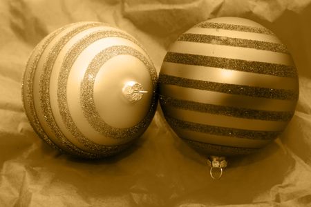 christmas golden balls on a gold color paper in the background