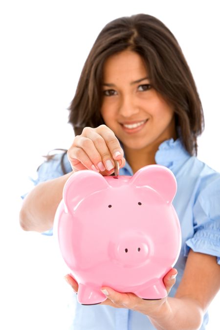 Woman saving money in a piggy bank isolated over a white background