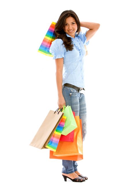 Casual woman standing with shopping bags isolated over a white background