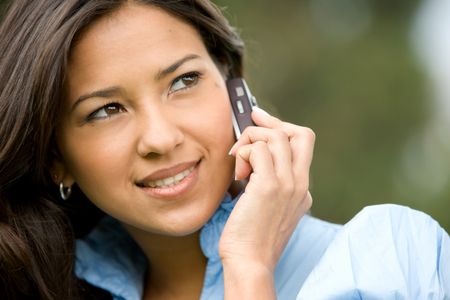 casual woman talking on a mobile phone outdoors