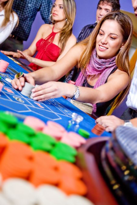 group of people on the casino roulette table playing