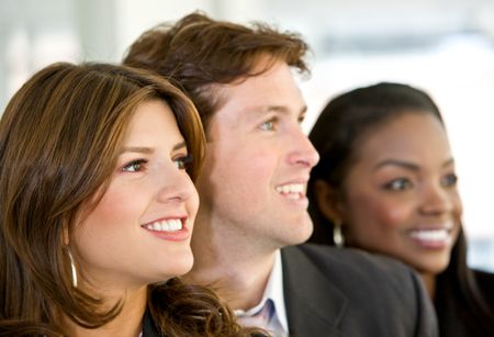 Business people in an office smiling - small team