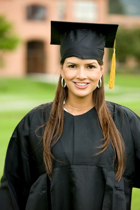 female graduate smiling and looking happy outdoors
