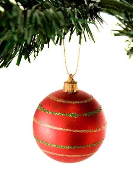 bauble in red hanging from christmas tree over white
