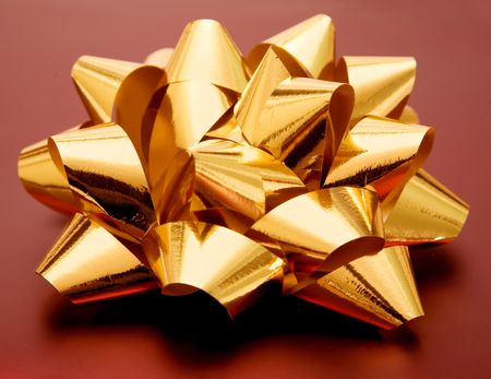 golden gift ribbon placed on a dark red present