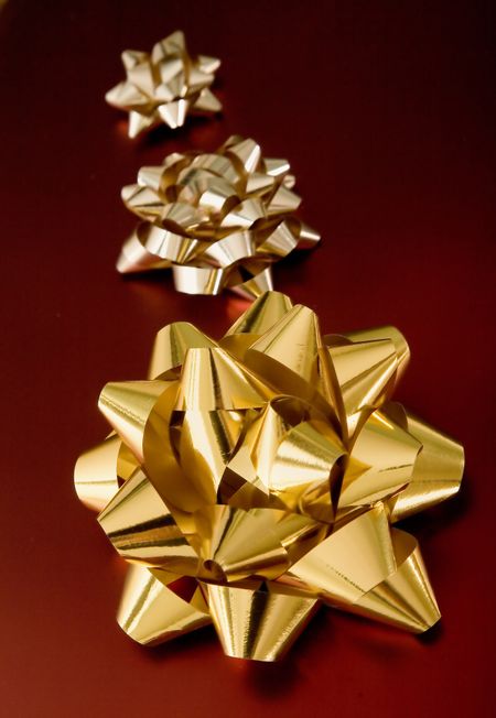 golden birthday or christmas ribbons on red gifts